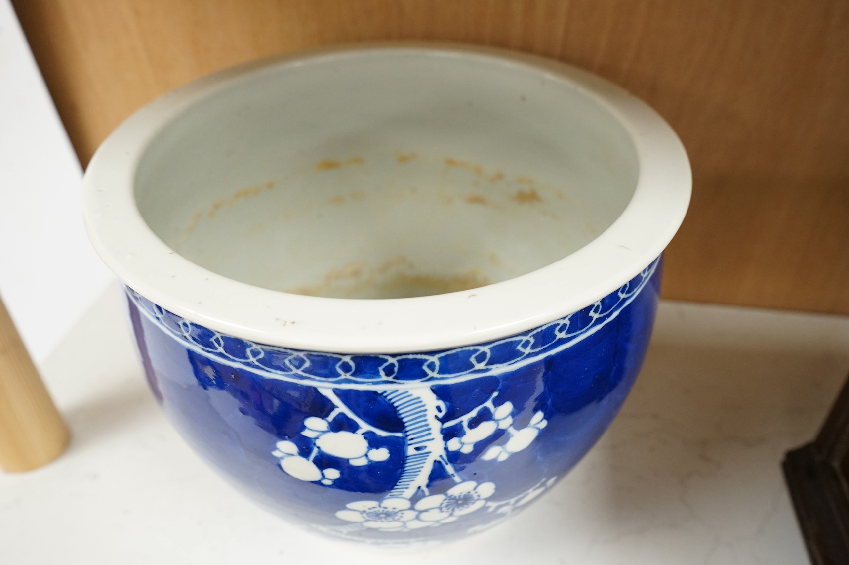 A Chinese blue and white ‘prunus’ jardiniere, 20cm tall. Condition- chipped